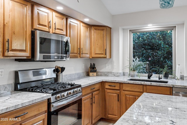 4493 E Desert Sands Dr, Chandler, AZ 85249 - kitchen featuring stainless steel appliances, a sink, light stone countertops, and brown cabinetry