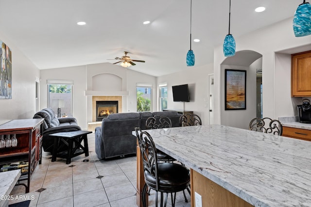 4493 E Desert Sands Dr, Chandler, AZ 85249 - dining space with vaulted ceiling, a ceiling fan, light tile patterned floors, a tile fireplace, and recessed lighting