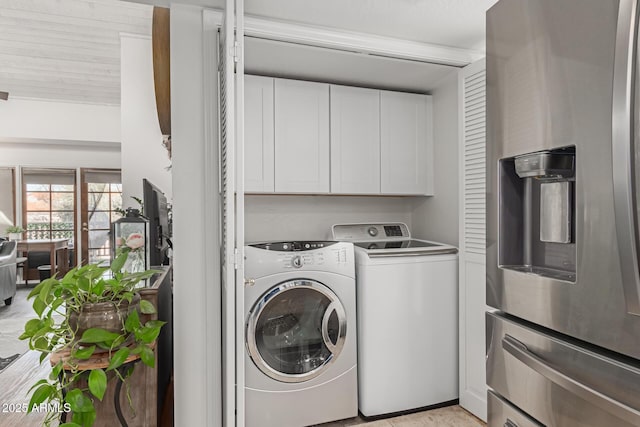 laundry room with cabinet space and separate washer and dryer