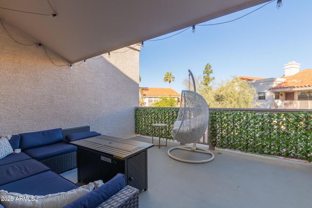 view of patio featuring an outdoor hangout area and a balcony