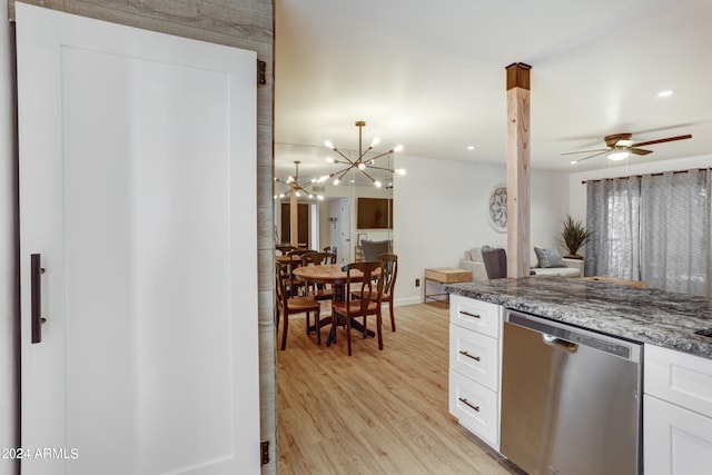 kitchen featuring light hardwood / wood-style flooring, white cabinets, dark stone countertops, and stainless steel dishwasher