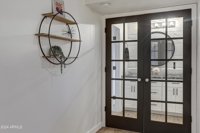 entryway with french doors and light hardwood / wood-style floors