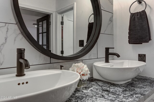 bathroom with tile walls and sink