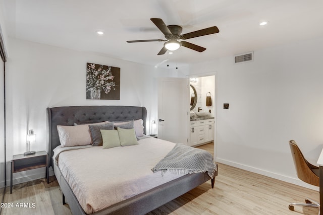 bedroom with connected bathroom, light hardwood / wood-style floors, and ceiling fan