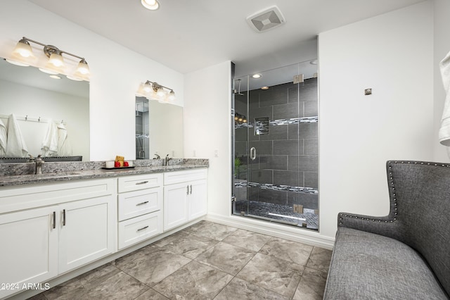 bathroom with vanity and a shower with shower door