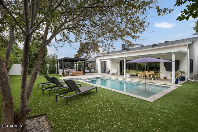 view of swimming pool with a yard and a patio area