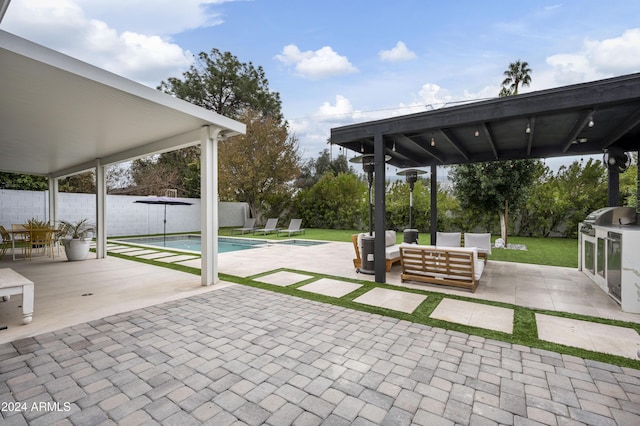 view of patio featuring an outdoor hangout area, a fenced in pool, and a grill