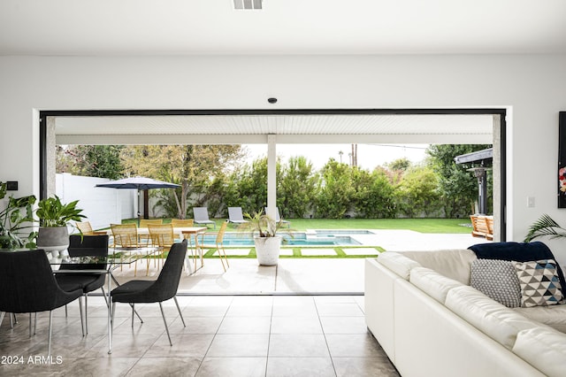 doorway to outside featuring light tile patterned flooring