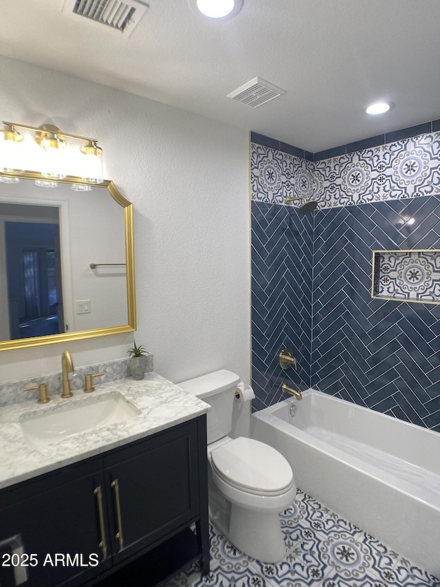 full bathroom with toilet, vanity, tiled shower / bath combo, and tile patterned flooring