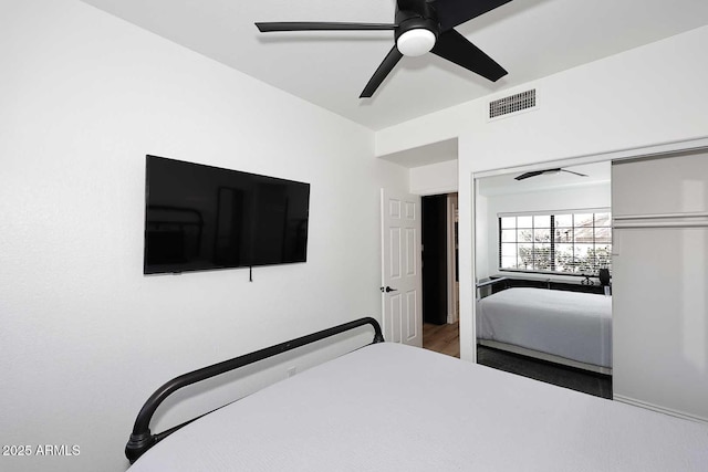 bedroom with ceiling fan and a closet