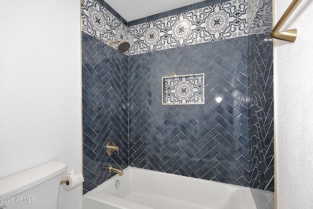 bathroom featuring toilet and tiled shower / bath