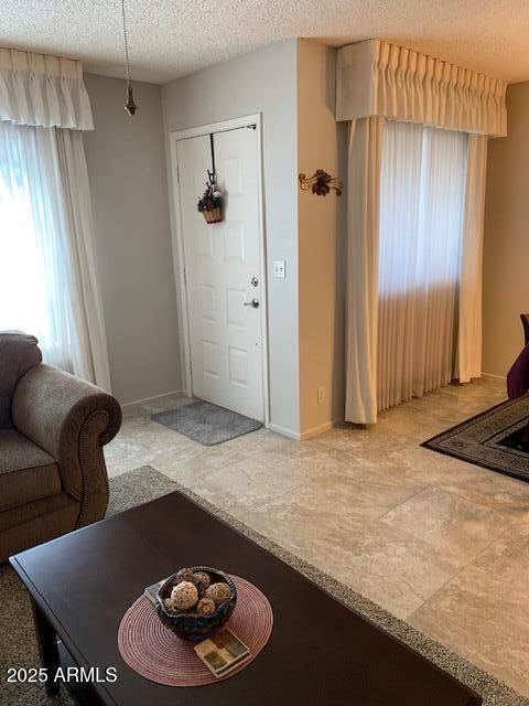 foyer entrance with a textured ceiling