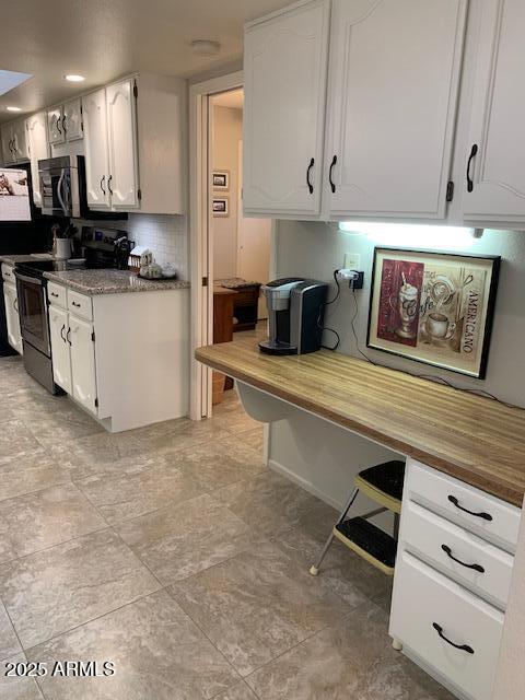 kitchen with white cabinetry, appliances with stainless steel finishes, and wooden counters