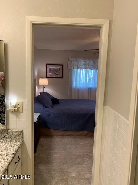 bedroom with tile walls