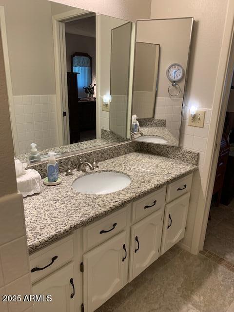 bathroom featuring tile walls, vanity, and tile patterned flooring