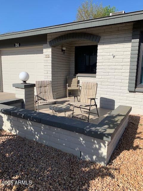 view of patio featuring a garage