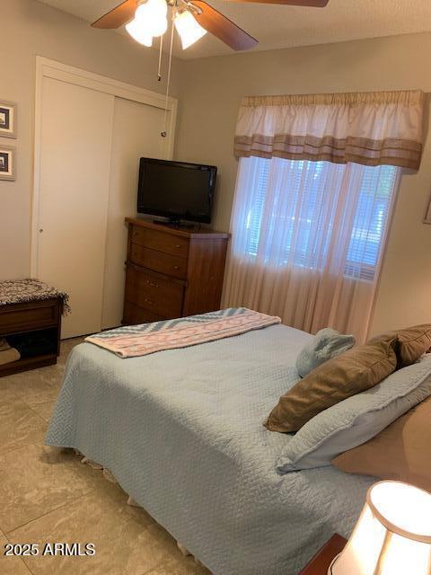 bedroom featuring ceiling fan and a closet