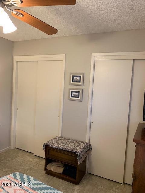 entrance foyer with ceiling fan and a textured ceiling