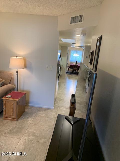 hallway with a textured ceiling