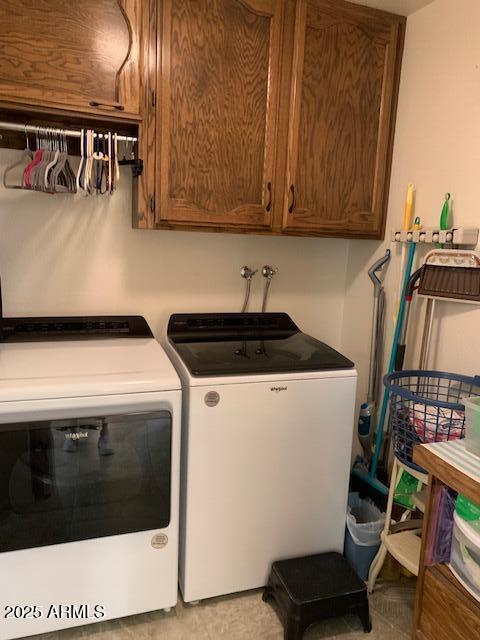 laundry room featuring independent washer and dryer and cabinets