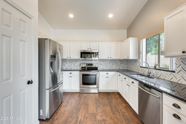 4041 W Hackamore Dr, Phoenix, AZ 85083 - kitchen with stainless steel appliances, a sink, dark stone countertops, decorative backsplash, and white cabinets