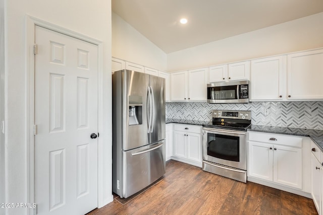 4041 W Hackamore Dr, Phoenix, AZ 85083 - kitchen with appliances with stainless steel finishes, lofted ceiling, decorative backsplash, white cabinetry, and dark wood-style flooring
