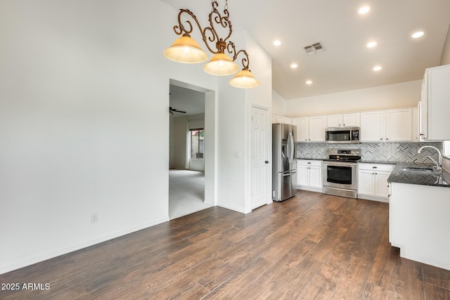 4041 W Hackamore Dr, Phoenix, AZ 85083 - kitchen featuring stainless steel appliances, a sink, backsplash, dark wood-type flooring, and lofted ceiling