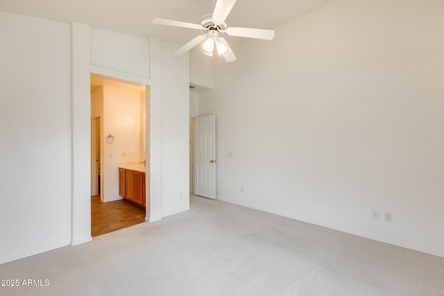 4041 W Hackamore Dr, Phoenix, AZ 85083 - unfurnished bedroom with light carpet, a towering ceiling, connected bathroom, and ceiling fan