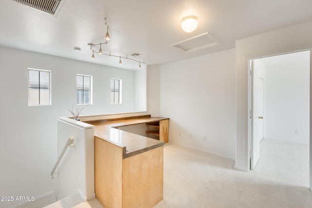4041 W Hackamore Dr, Phoenix, AZ 85083 - kitchen with light carpet, light brown cabinets, rail lighting, and baseboards