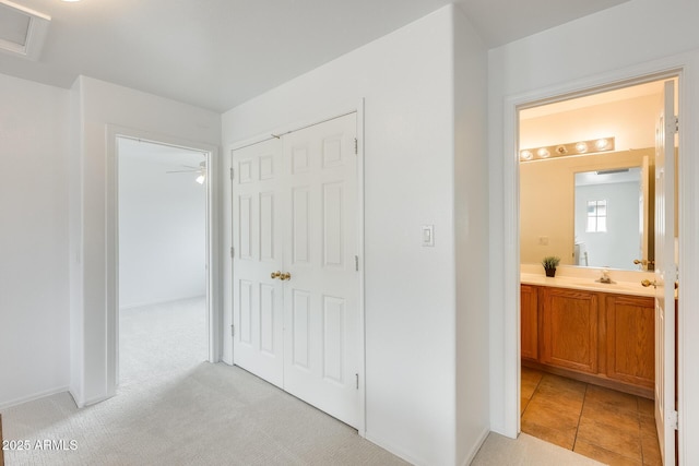 4041 W Hackamore Dr, Phoenix, AZ 85083 - corridor featuring a sink and light carpet