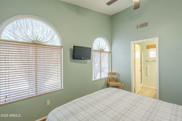 bedroom with ceiling fan and ensuite bath