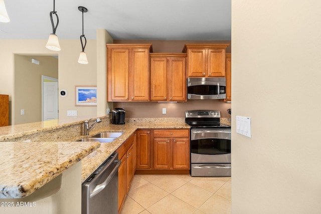 kitchen featuring kitchen peninsula, appliances with stainless steel finishes, light tile patterned flooring, pendant lighting, and sink