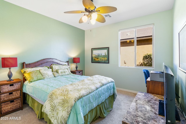 bedroom with ceiling fan and light carpet