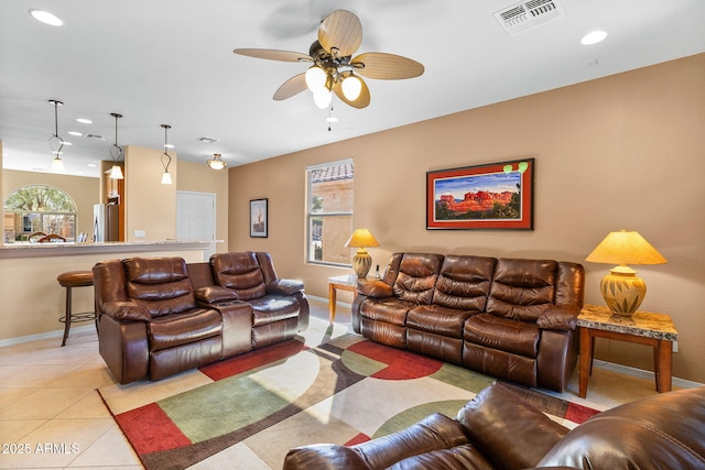 living room with ceiling fan and light tile patterned flooring