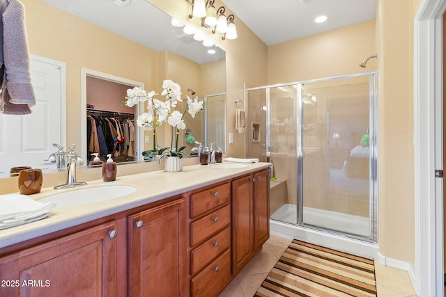 bathroom with vanity, tile patterned flooring, and a shower with door