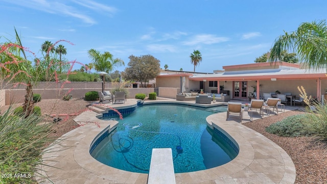12682 N 80th Pl, Scottsdale, AZ 85260 - view of swimming pool featuring outdoor lounge area, a fenced backyard, a patio area, french doors, and a diving board