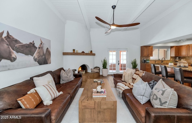 12682 N 80th Pl, Scottsdale, AZ 85260 - living area with a ceiling fan, french doors, a large fireplace, high vaulted ceiling, and a wooden ceiling with exposed beams