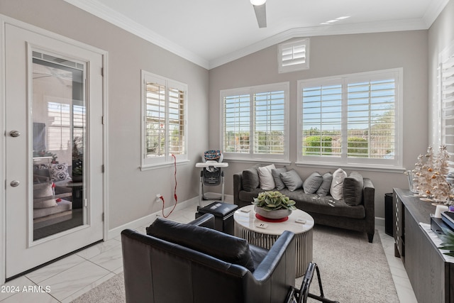 living room featuring ceiling fan, a healthy amount of sunlight, ornamental molding, and vaulted ceiling