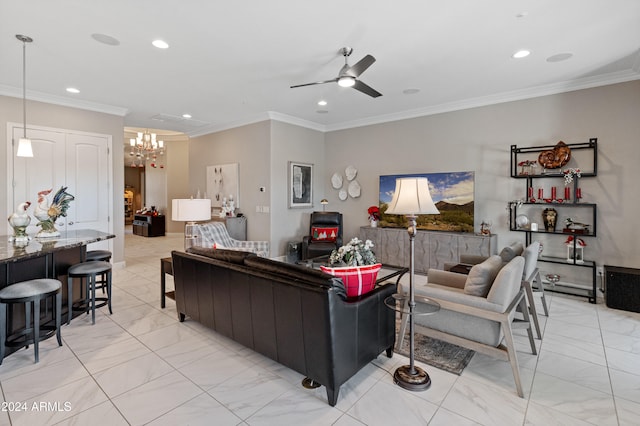 living room featuring ceiling fan with notable chandelier and crown molding