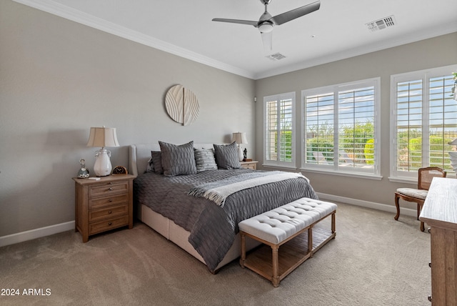 carpeted bedroom with ceiling fan and crown molding