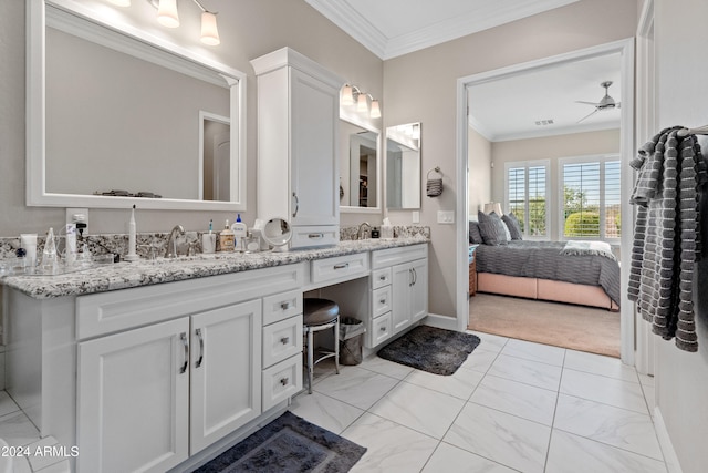 bathroom featuring ceiling fan, ornamental molding, and vanity