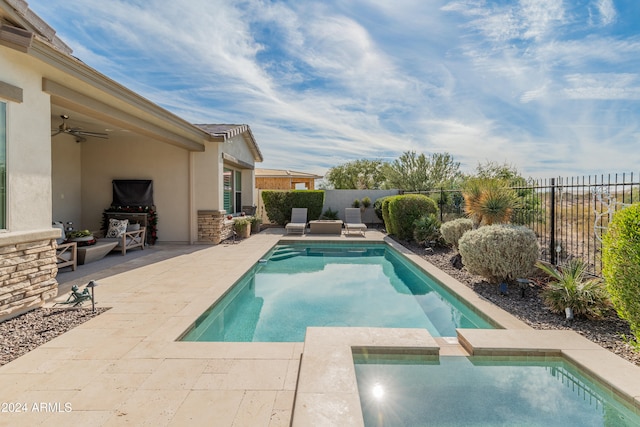 view of pool with a patio area and ceiling fan