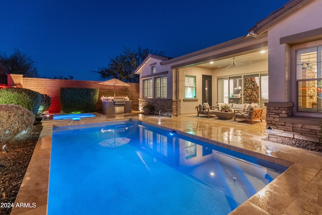 pool at twilight with an in ground hot tub, an outdoor hangout area, ceiling fan, and a patio area