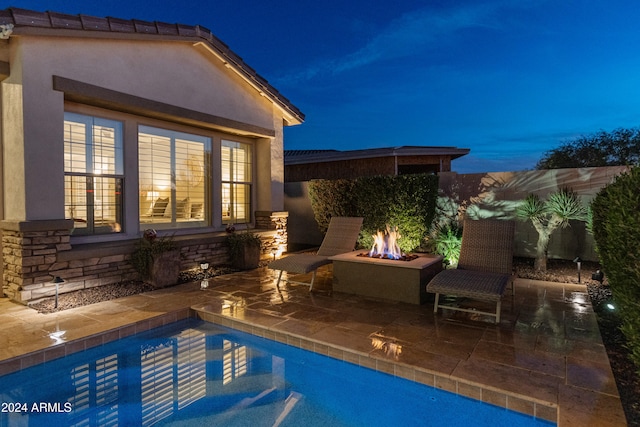 view of pool featuring a patio and an outdoor fire pit