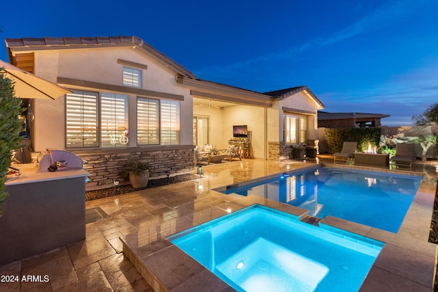 view of swimming pool with an in ground hot tub, ceiling fan, exterior kitchen, and a patio