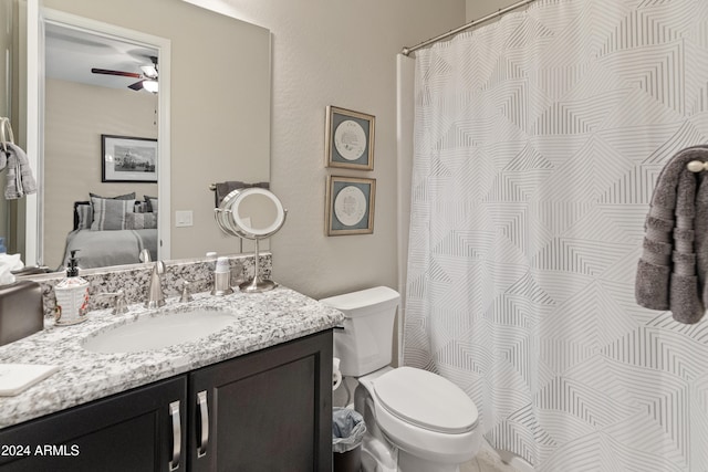 bathroom with vanity, toilet, and ceiling fan