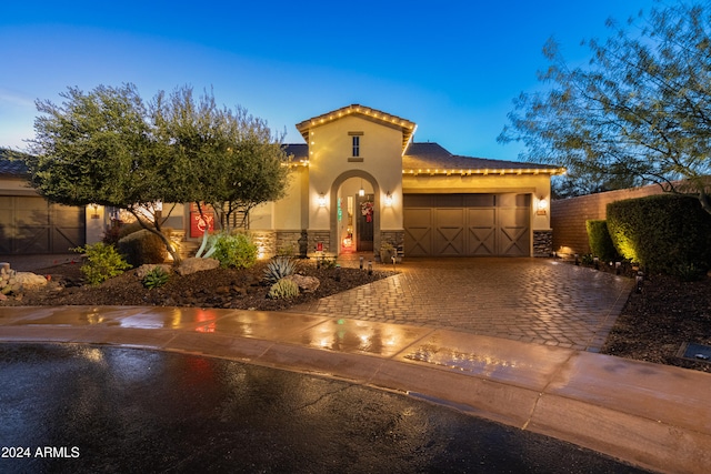 mediterranean / spanish-style house with a garage