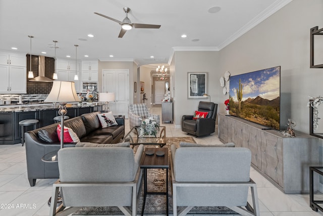 living room with ceiling fan with notable chandelier, ornamental molding, and light tile patterned flooring