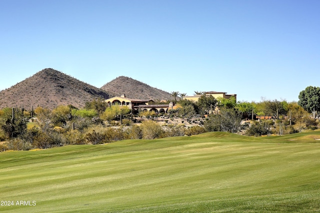 view of property's community featuring a mountain view and a yard