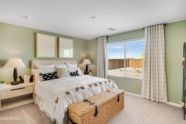 bedroom with baseboards, light carpet, and visible vents